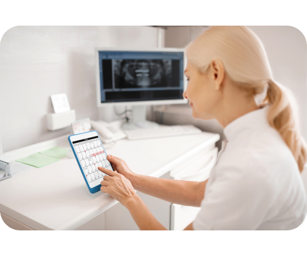 Dentist at a workstation determining staff schedules